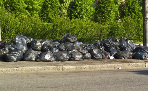 Segregated waste and recycling bins at a clearance site